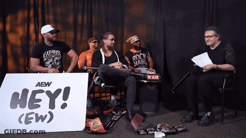 Men Sitting In Front Of Hey (Ew) Sign GIF