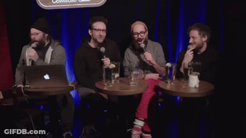 Men Sitting In Front Of Scoop Sign GIF