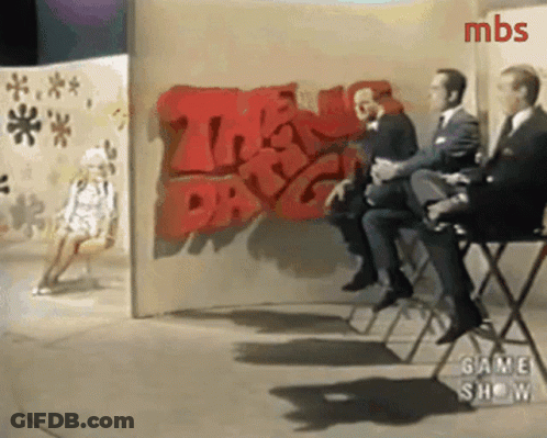 Men Sitting In Front Of Wall Saying The Day GIF