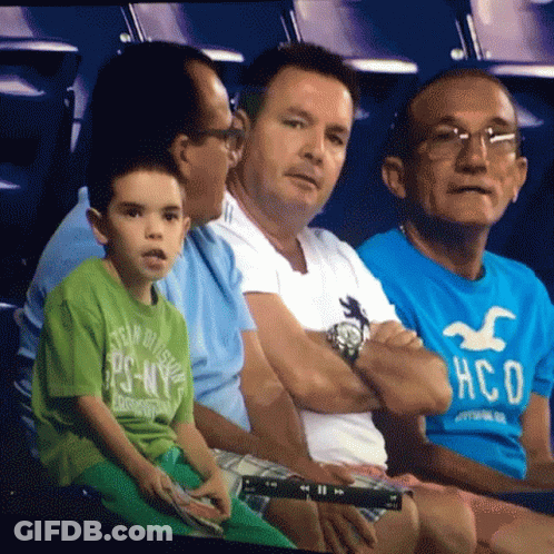 Men Sitting In Stadium, One Wearing Hollister Shirt GIF