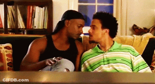 Men Sitting On Couch Looking At Each Other GIF