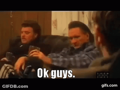 Men Sitting On Couch One Holding Beer GIF