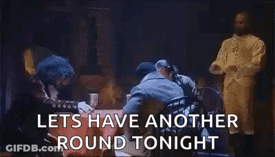 Men Standing Around Table Saying Let's Have Another Round Tonight GIF