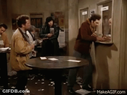 Men Standing Around Table GIF