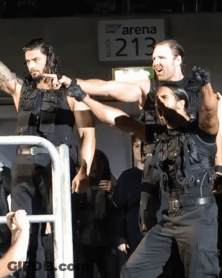 Men Standing In Front Of Arena 213 Sign GIF