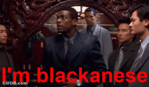 Men Standing In Front Of Blackanese Sign GIF