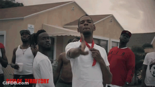 Men Standing In Front Of Building With Savage Territory GIF