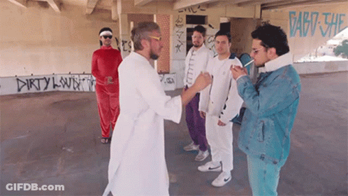 Men Standing In Front Of Dirty Clown Wall GIF