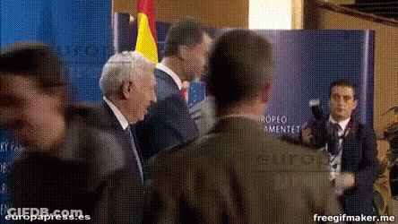 Men Standing In Front Of Europa Press.es Sign GIF
