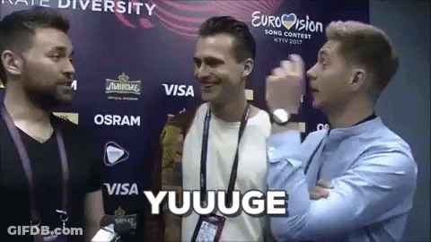 Men Standing In Front Of Eurovision Wall GIF