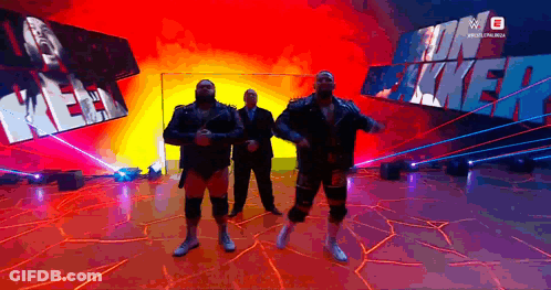 Men Standing In Front Of Kevin Mack Sign GIF