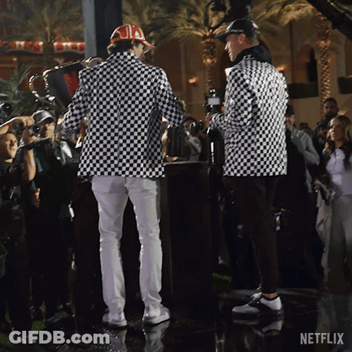 Men Standing In Front Of Netflix Logo GIF