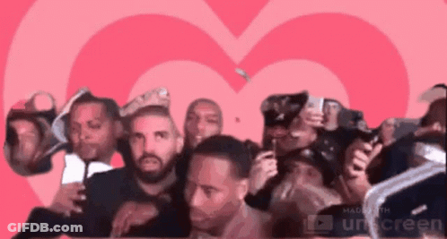 Men Standing In Front Of Pink Heart GIF