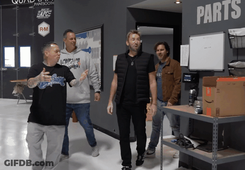 Men Standing In Front Of Wall Saying Parts GIF
