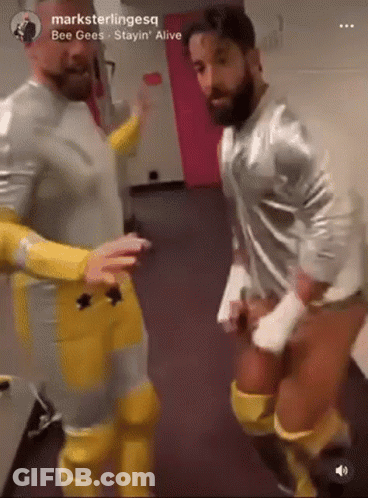 Men Standing In Hallway GIF