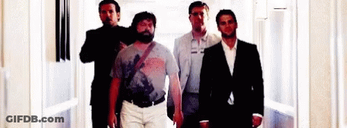 Men Standing In Hallway GIF