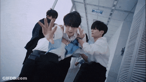 Men Standing In Hallway Near Blue Exit Sign GIF