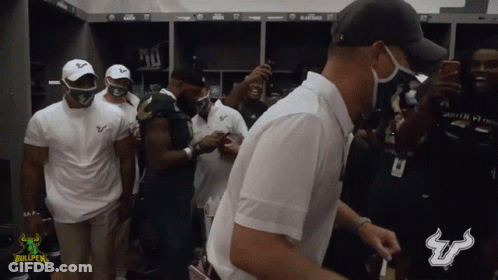 Men Standing In Locker Room With Bullpen Logo GIF