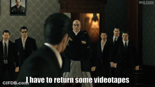 Men Standing In Room With I Have To Return Some Videotapes GIF