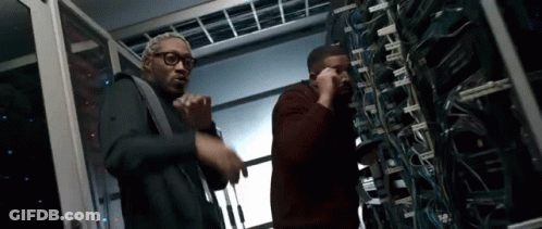 Men Standing Next To Each Other In Server Room GIF
