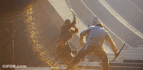 Men Standing On Stairs Holding Swords GIF