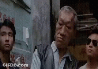 Men Standing Together In Front Of Building GIF