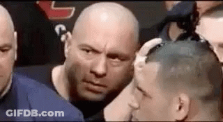 Men Surrounding Bald Man In Boxing Ring GIF
