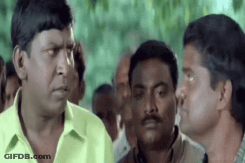 Men Talking In Crowd GIF