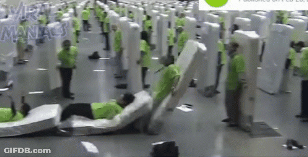 Men Toppling Down Domino Effect GIF