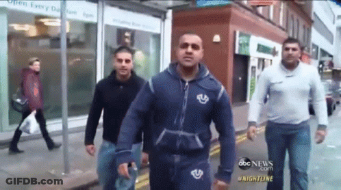 Men Walking Down Street With Open Every Day 8Am To 8Pm Sign GIF