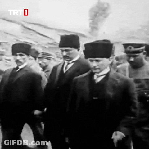 Men Walking In Front Of TRT 1 Screen GIF