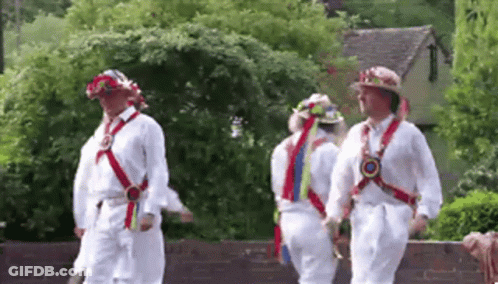 Men Walking In Line Wearing White Shirts And Hats GIF