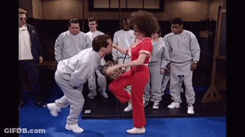 Men Watching Woman Kick Man At Everlast Bag GIF