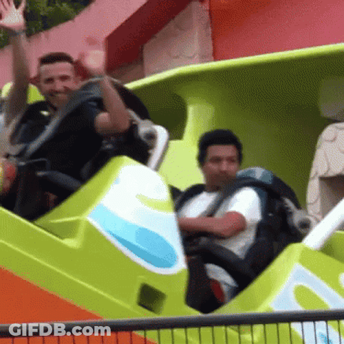 Men Waving While Taking Rides In Disneyland GIF