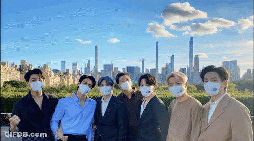 Men Wearing Face Masks With City Background GIF