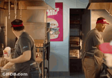 Men Working In Kitchen With Bake's Beef Sign GIF