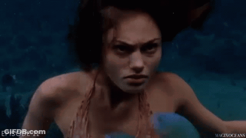 Mermaid Swimming In Ocean With Blue Fish GIF