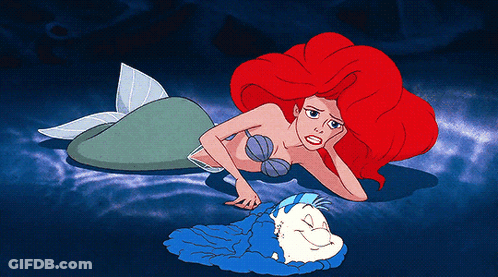 Mermaid With Red Hair Laying On Ground GIF