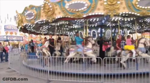 Merry Go Round With Eagle Claw Sign GIF