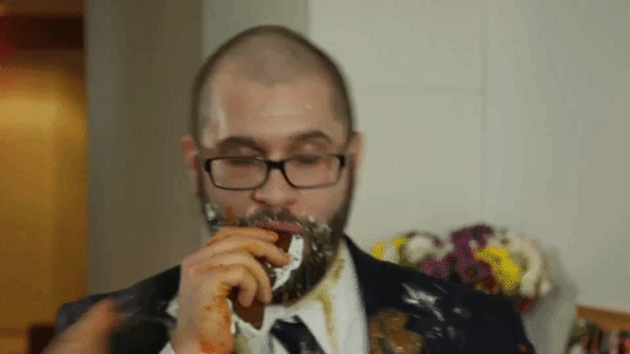 Messy Eater Man In Black Suit GIF