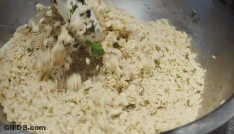 Metal Bowl Filled With Rice And Greens With Spatula GIF