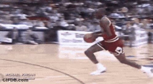 Michael Jordan Is Dribbling A Basketball On A Court . GIF