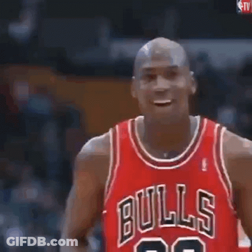 Michael Jordan Is Holding A Basketball In His Hands And Blowing It Up . GIF