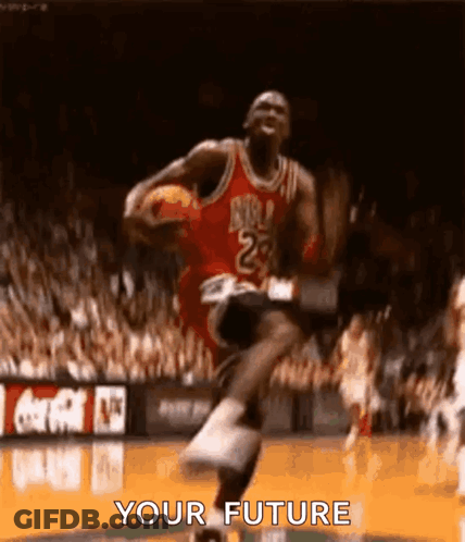 Michael Jordan Is Jumping In The Air While Holding A Basketball In His Hand . GIF