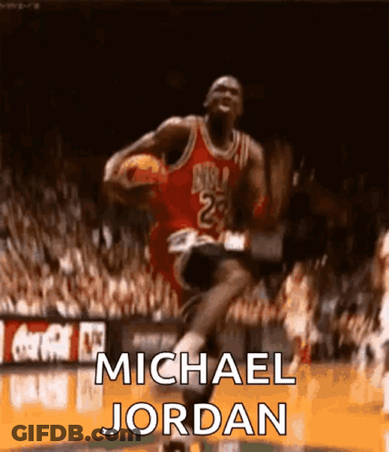 Michael Jordan Is Jumping In The Air With A Basketball In His Hand . GIF