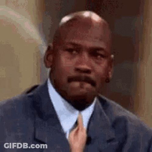 Michael Jordan Is Wearing A Suit And Tie While A Woman Holds His Tie . GIF
