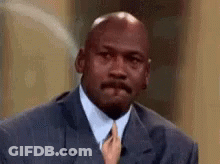 Michael Jordan Is Wearing A Suit And Tie With A Woman Holding His Tie . GIF