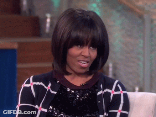 Michelle Obama In Plaid Sweater And Sequined Top GIF
