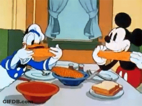 Mickey Mouse And Donald Duck Are Sitting At A Table Eating Sandwiches GIF
