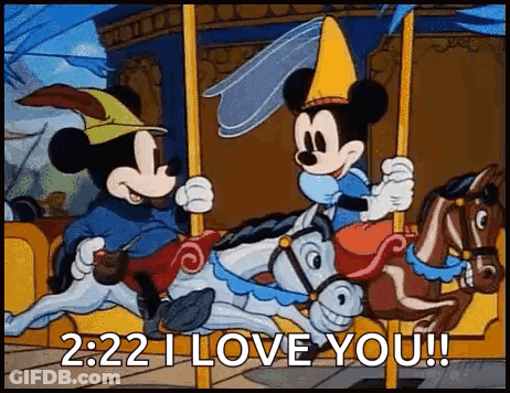 Mickey Mouse And Minnie Mouse Are Riding A Merry Go Round On A Carousel . GIF